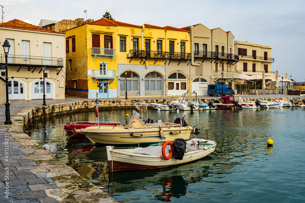 beautiful morning photo of a sunrise over the greek fishing port in rethymno, crete, greece