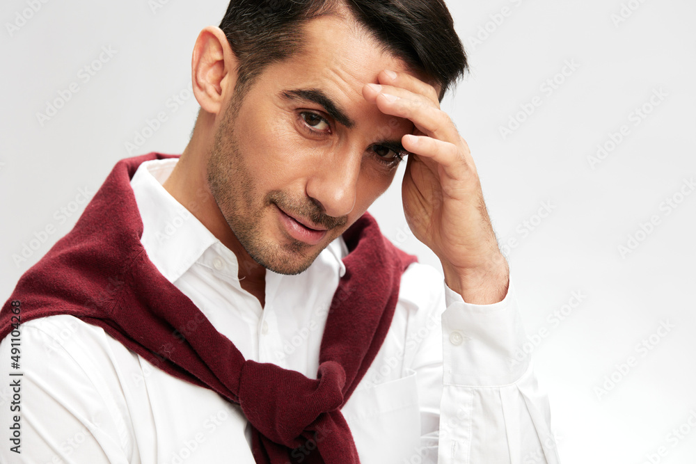 businessman portrait in a white shirt sweater on the shoulders pensive look light background businessman portrait in a white shirt sweater on the shoulders pensive look light background