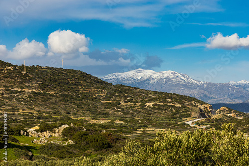 Beautiful panorama shot of a countryside and mountain peak with snow in Crete, Greece