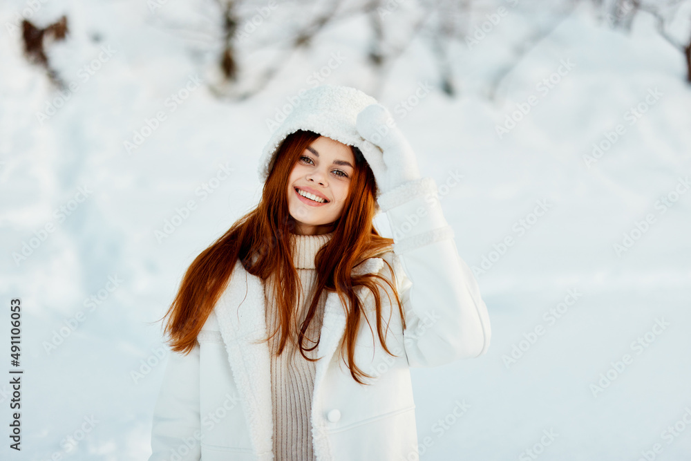 beautiful woman in a white coat in a hat winter landscape walk Lifestyle beautiful woman in a white coat in a hat winter landscape walk Lifestyle