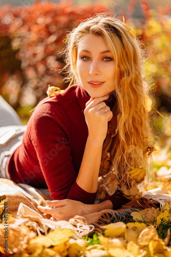 an blonde woman on a autumn lawn. shampoo and cosmetics for hair care. 