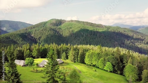 Mountain peaks and morning sky with smooth moving clouds. Summer landscape paeceful valley trees in the meadow at Carpathian mountains. Ukraine. photo