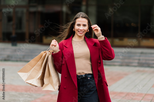 Happy woman with shopping bags enjoying shopping. Consumerism, lifestyle concept