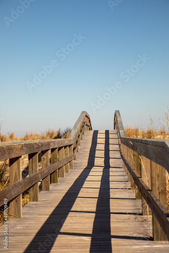 Boardwalk to the beach with blue skies © karenfoleyphoto