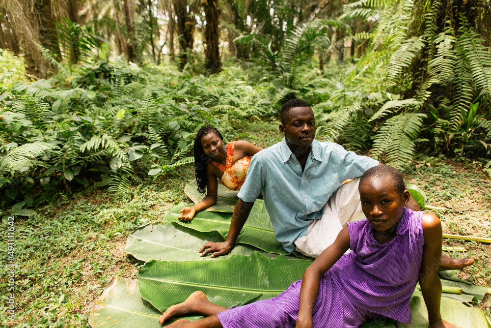 Above shot of a black african family of farmers sitting in the rainforest Above shot of a black african family of farmers sitting in the rainforest