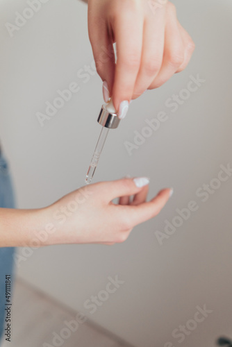 woman hands take care with cosmetics to her skin photo