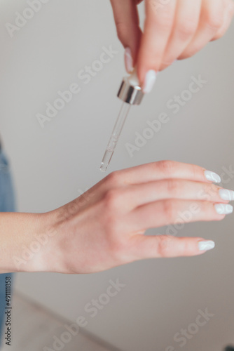 woman hands take care with cosmetics to her skin