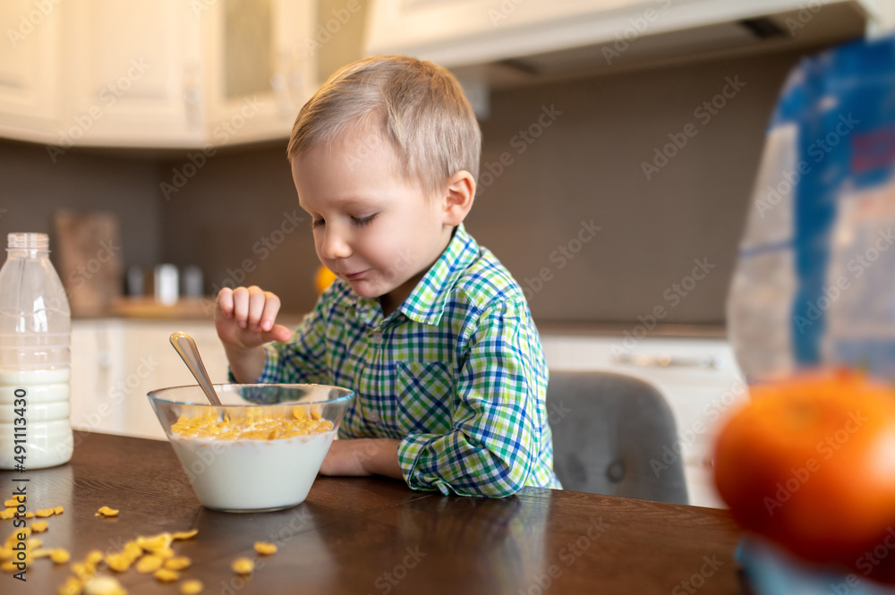 Focused kid staring at his ready-to-eat oats