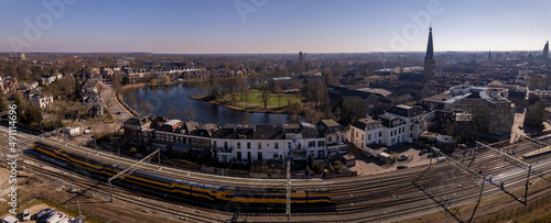 Aerial of park and Grote Gracht canal in historic tower town Zutphen, The Netherlands with train tracks in the foreground