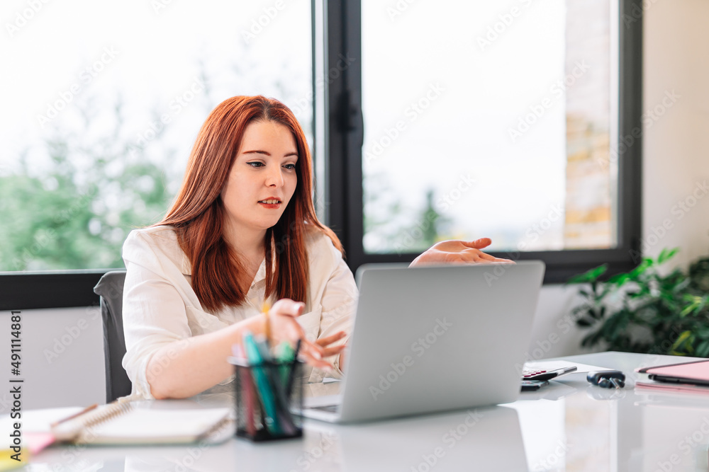 Young girl in a video conference at work Young girl in a video conference at work