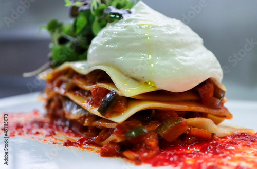 Vegetable lasagna with anchovies and piparra foam photo