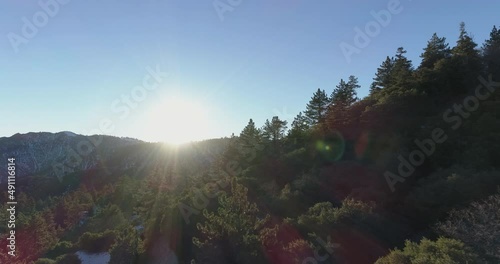 Aerial drone flight over forest and Mountain at sunset