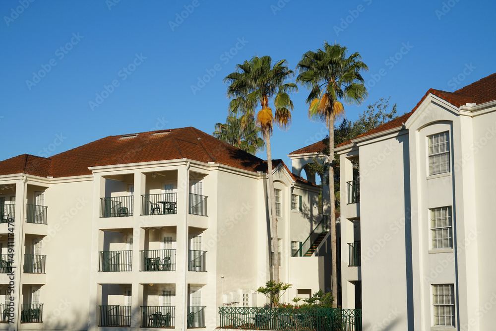 apartment buildings with palm tree in tropical area apartment buildings with palm tree in tropical area