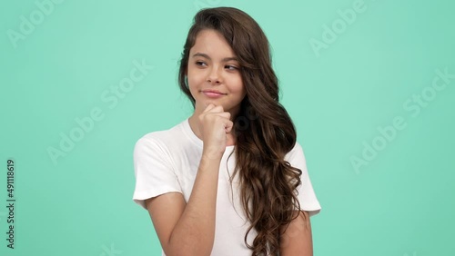 closeup portrait of pondering child long curly hair with smiling face, good mood photo