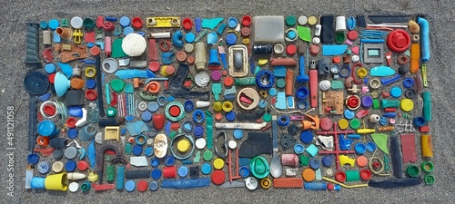 spilled plastic garbage on the beach, dirty sea sandy shore, environmental pollution, ecological problem, aerial view of plastic garbage on the beach, garbage on the beach, still lifes of plastics