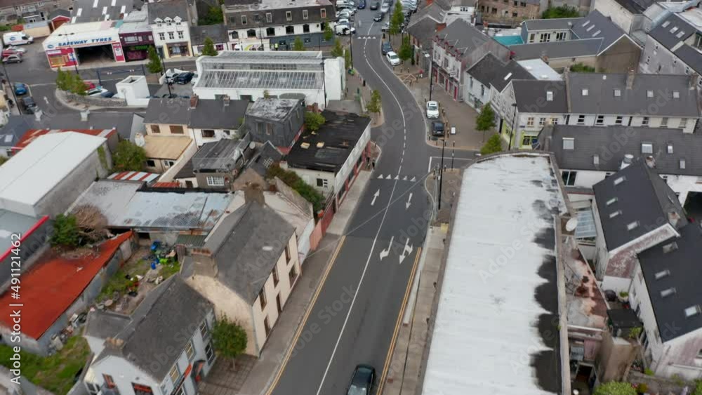 High angle view of street and crossroads in town. Various buildings along road. Cars driving in town centre. Ennis, Ireland High angle view of street and crossroads in town. Various buildings along road. Cars driving in town centre. Ennis, Ireland