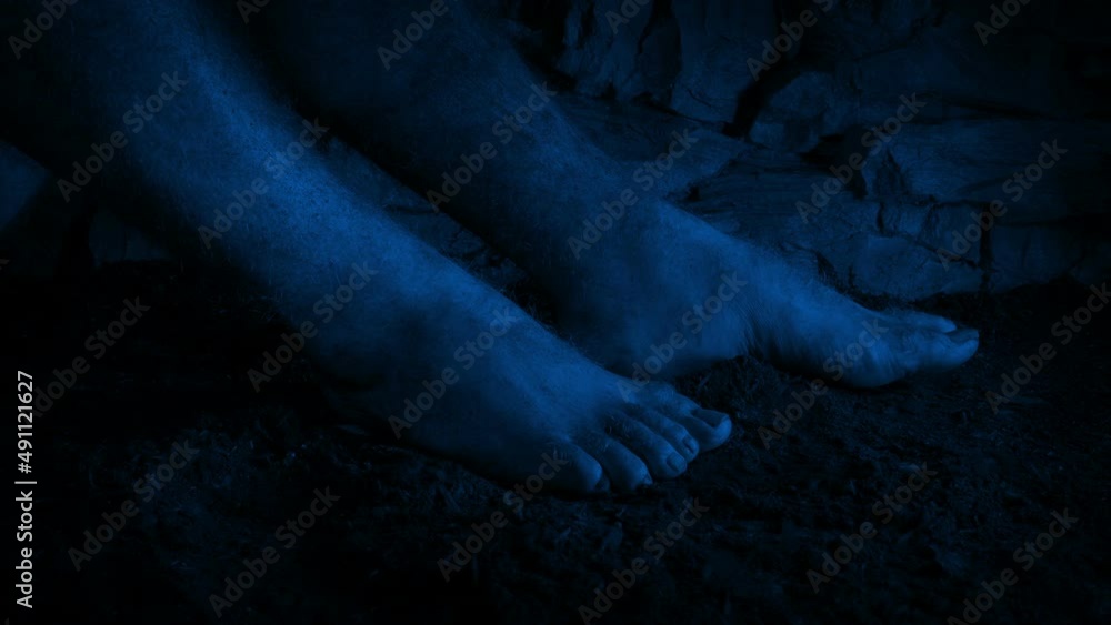 Man Sitting On Dirt Floor In The Dark Man Sitting On Dirt Floor In The Dark
