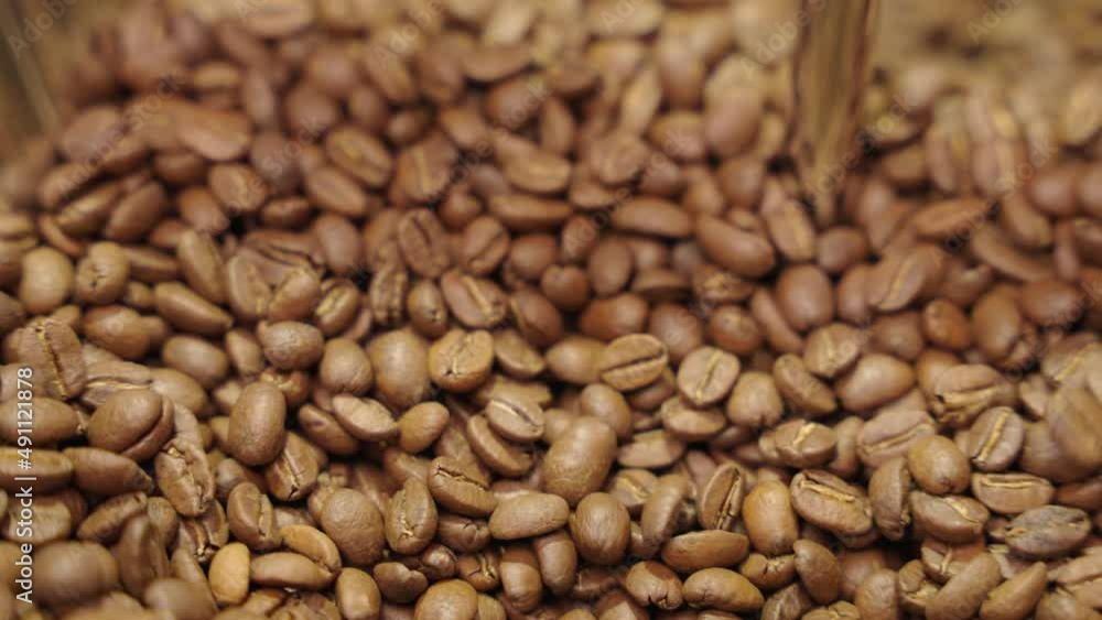 hand glides slowly through coffee beans slow motion close up hand glides slowly through coffee beans slow motion close up
