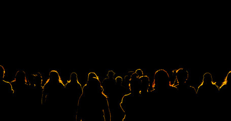 Light shining on crowd of people with yellow outlined silhouettes of bodies on a black background