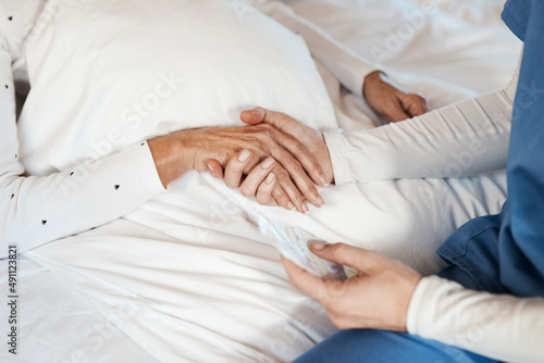 Give someone your hand and you give them hope. Cropped shot of a nurse holding hands with a senior woman.