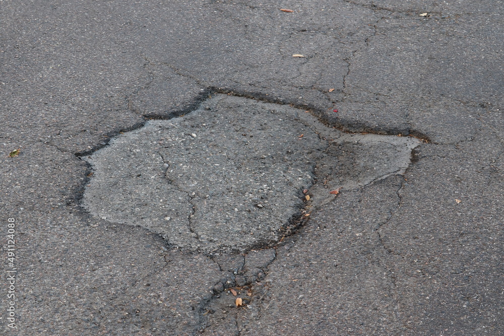Fototapeta premium Asphalt Breaking Up Due to Sun and Rain