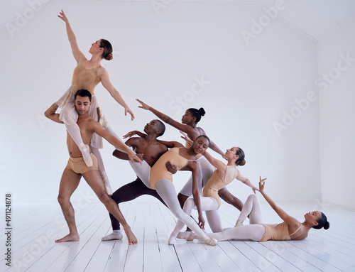 Perfectly positioned. Shot of a group of ballet dancers practicing a routine in a dance studio.