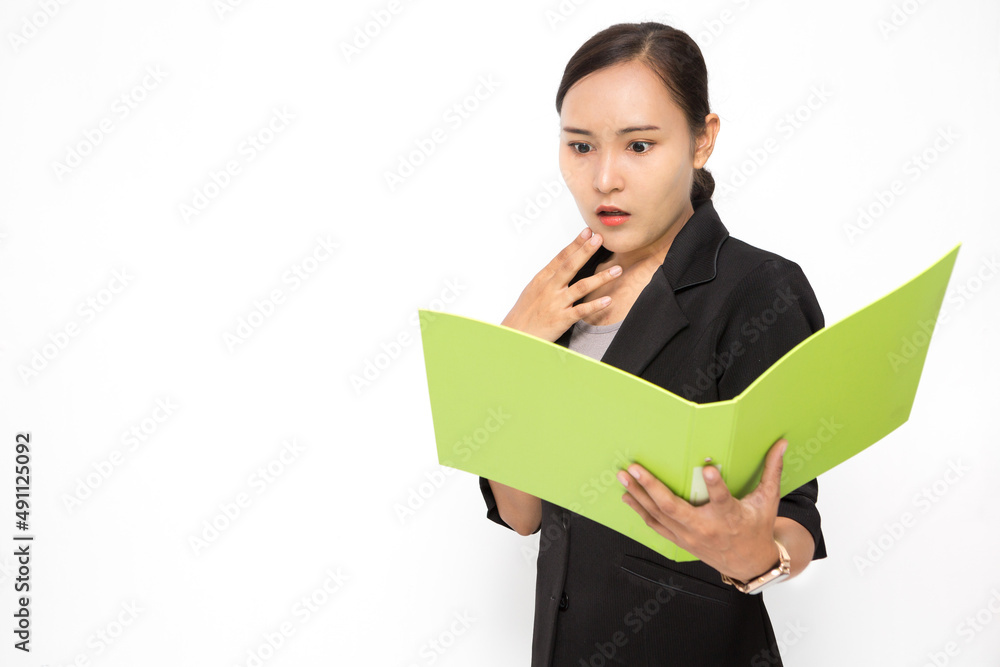Beautiful Asian business woman wearing black suit look at document folder and shocked with something on white background and copy space Beautiful Asian business woman wearing black suit look at document folder and shocked with something on white background and copy space