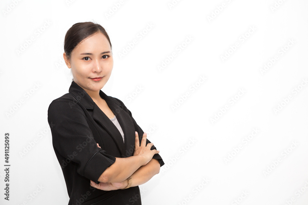 Beautiful Asian business woman wearing black suit with her crossed arms on white background and copy space. Confident Asian working woman smiling and cheerful Beautiful Asian business woman wearing black suit with her crossed arms on white background and copy space. Confident Asian working woman smiling and cheerful