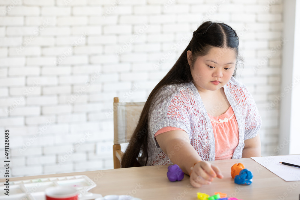 down syndrome girl sculpt plasticine figures on a table down syndrome girl sculpt plasticine figures on a table