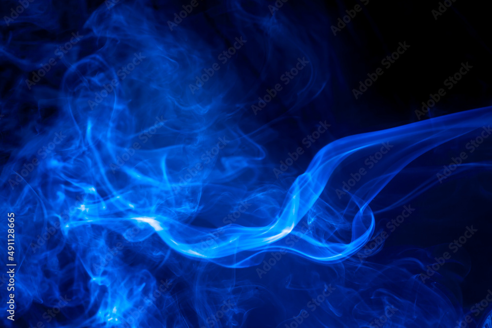 Blue smoke on black background.