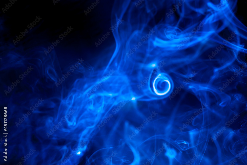 Obraz premium Blue smoke on black background.