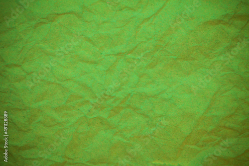 Green crumpled paper background.