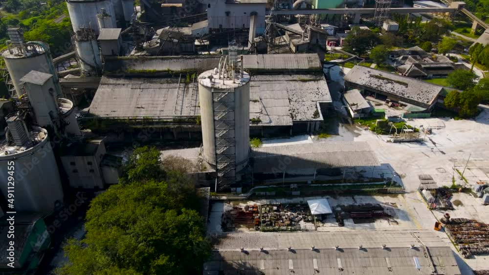 Aerial view of cement plant factory at industrial production area during sunrise. Aerial view of cement plant factory at industrial production area during sunrise.