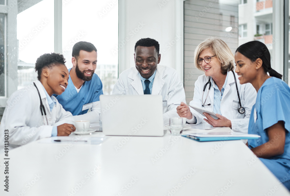Its all about exceptional healthcare. Shot of a group of medical practitioners using a laptop during a meeting in a hospital boardroom. Its all about exceptional healthcare. Shot of a group of medical practitioners using a laptop during a meeting in a hospital boardroom.
