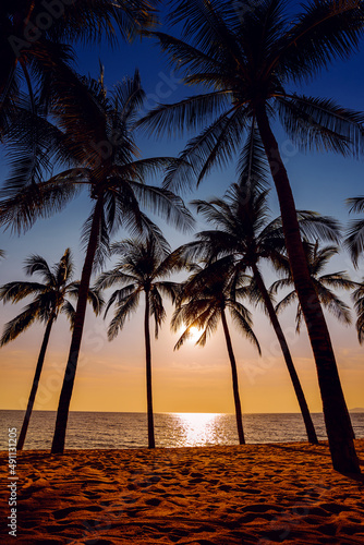 close up sand beach with coconut trees background at sunset