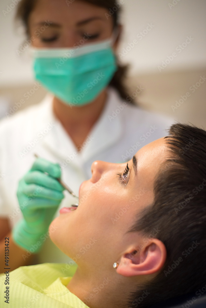 Young woman checking her teeth at the dentist clinic. Young woman checking her teeth at the dentist clinic.