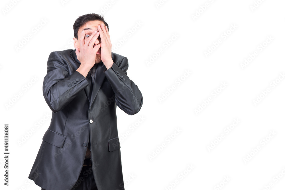 Terrified guy covering face against white background Terrified guy covering face against white background