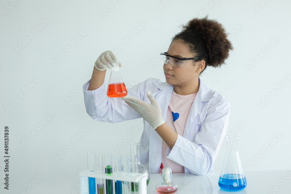 Girl scientist research liquid chemical experiments in white laboratory room. school girl students study research holding test tube with learning biotechnology. science education concept. Girl scientist research liquid chemical experiments in white laboratory room. school girl students study research holding test tube with learning biotechnology. science education concept.
