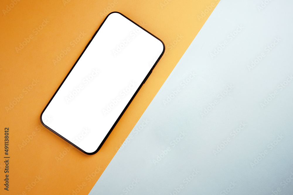 Overhead phone mockup with white screen and contrast yellow and teal background with copy space Overhead phone mockup with white screen and contrast yellow and teal background with copy space