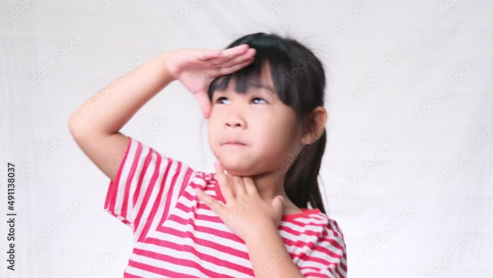 Cute little girl holding hand at forehead, looking far away distance on white background in studio. Cute little girl holding hand at forehead, looking far away distance on white background in studio.