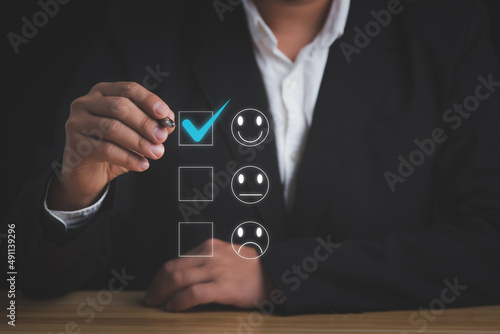Customer satisfaction survey concept.Businessman giving rating with a happy icon.