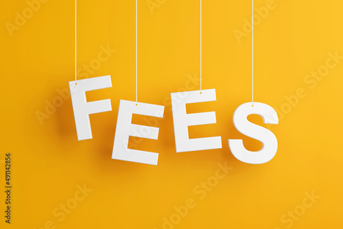 The word fees levitates on yellow background. photo
