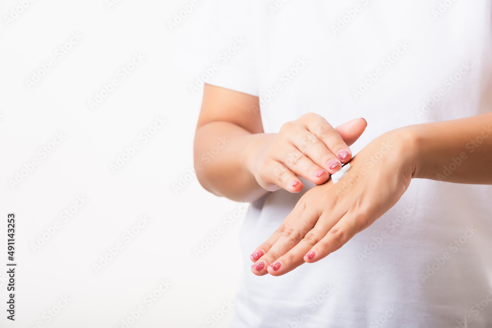 Closeup young Asian woman applying lotion cosmetic moisturizer cream on her behind the palm skin hand, studio shot isolated on white background, Healthcare medical and hygiene skin body care concept Closeup young Asian woman applying lotion cosmetic moisturizer cream on her behind the palm skin hand, studio shot isolated on white background, Healthcare medical and hygiene skin body care concept