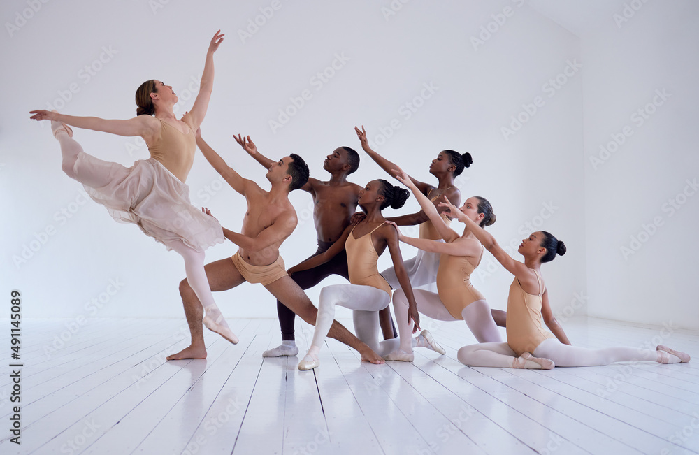 Naklejka premium Creating beauty. Shot of a group of ballet dancers practicing a routine in a dance studio.