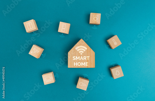 Controlling smart home concept, Wireless connections with icons home electronics on wooden block.