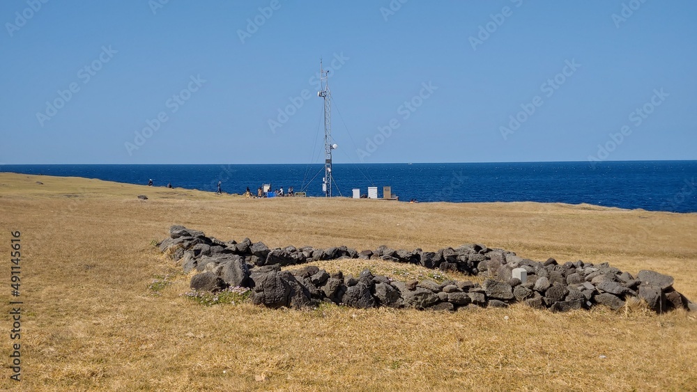 A pile of stones and a survey tower built near the beach.