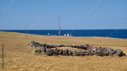 A pile of stones and a survey tower built near the beach.