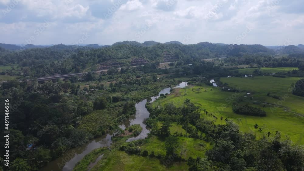 drone flying towards river with hills on horizon in Sri Lanka drone flying towards river with hills on horizon in Sri Lanka