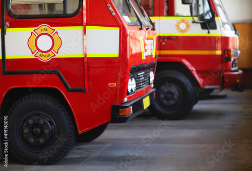 Ready for action. Cropped shot of parked fire engines.