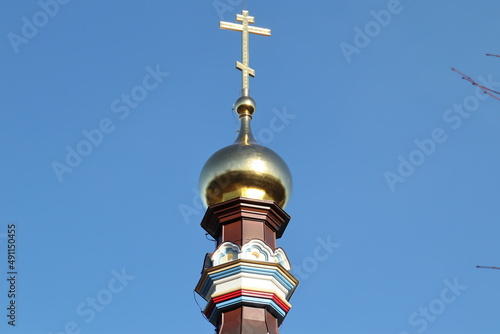 golden cross on blue sky photo